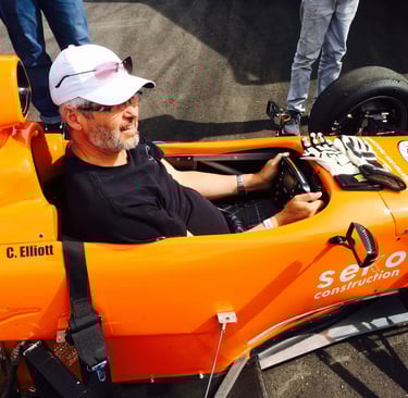 allan barss sitting in an open wheel style racecar 