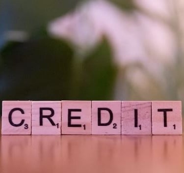 a wooden block with the words credit card on it