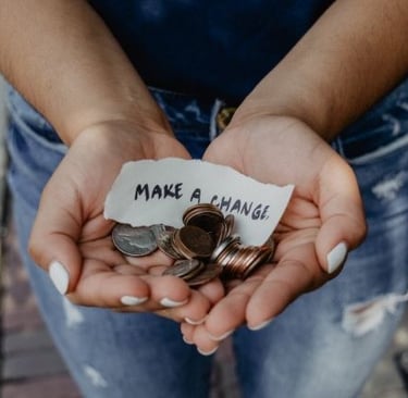 a person holding a not that says make a change