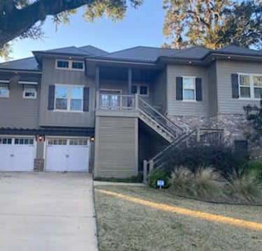 a house with a driveway and garage door