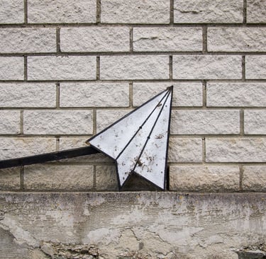 an email sign against a brick wall