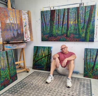 Kevin McKeown, Australian artist, sitting in his Perth studio surrounded by original abstract landscape paintings in his Chro