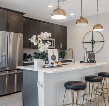 a kitchen with a large island and a bar stool