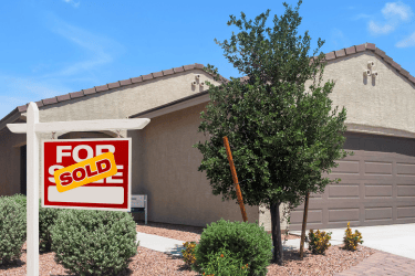a for sale sign in front of a house with a for sale sign