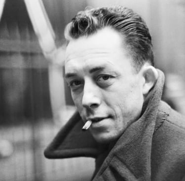 A black and white potrait of french writer ablert camus smoking a cigarette.