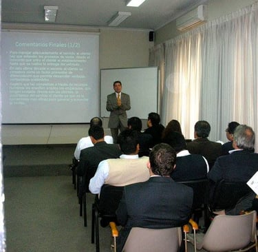 Professional business seminar presentation with a speaker leading a corporate training workshop for an audience.