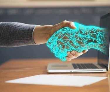 une main d'homme et une main de robot qui ce serre