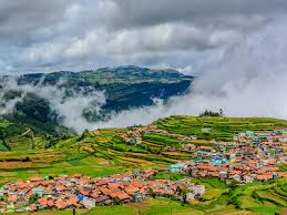 Misty Kodaikanal hill station view with terraced village, a popular tour destination from Chennai.