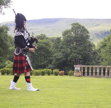 Tony piping for a memorial service at a funeral in Stirlingshire, Scotland. He is wearing the full n