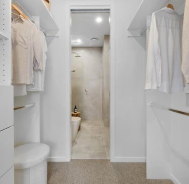walk in wardrobe through to two basin bathroom