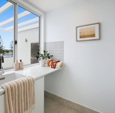a laundry with a view at Arvia Villa Koala Park with a sink and a window