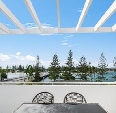 a table with a table and chairs on a balcony private terrace and barbecue overlooking tallebudgera c