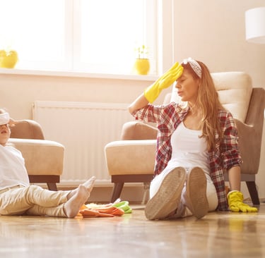 Mother and child taking a break after house cleaning in a bright living room, in Melbourne, FL