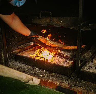 a person is cooking food on a grill