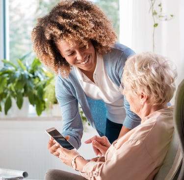 elderly woman with age related macular degeneration getting cell phone training for visual impairment