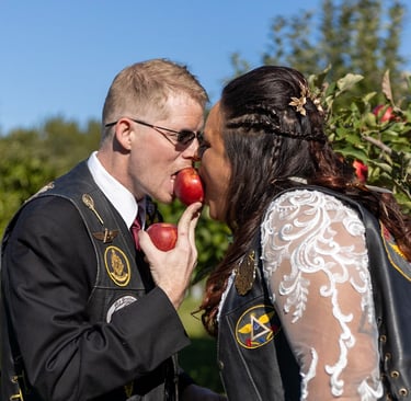 a man and woman kissing in a field