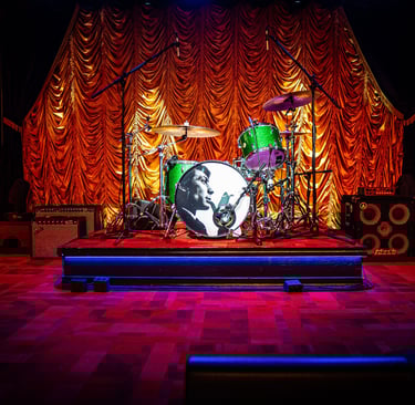 The Eighth Room stage in Nashville featuring warm lighting, gold drapery, and a Martin Audio sound s