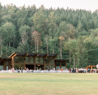a large group of people standing around a large building