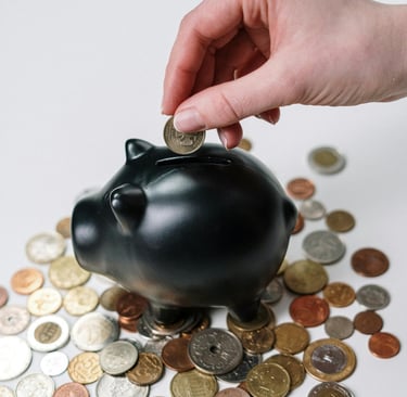 Uma pessoa colocando dinheiro em um cofrinho, simulando a poupança.