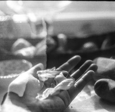 a hand holding delicate matter, being inspected and measured