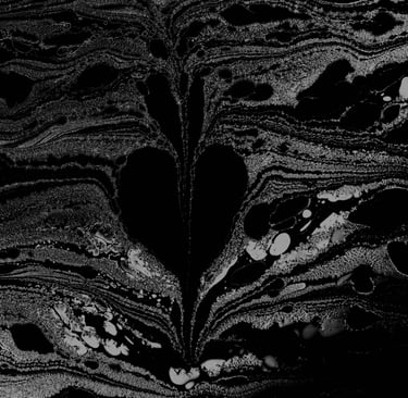 A bleeding heart found emerging from formed and swirling ink on water