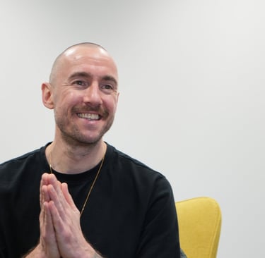 meditation teacher in black t shirt smiling