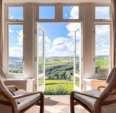 an open door looks out onto a countryside view