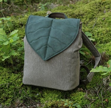 a backpacker's backpacker with a leaf shaped leaf on it