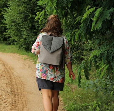 a woman walking with a handmade vegan backpack