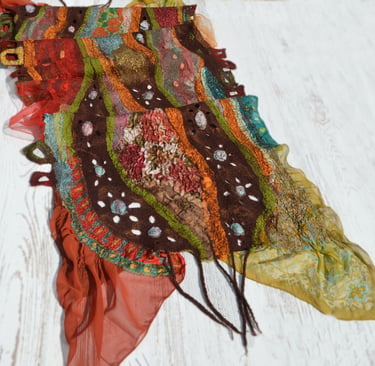 Handmade nuno felted scarf with colorful abstract wool patterns and silk textures.