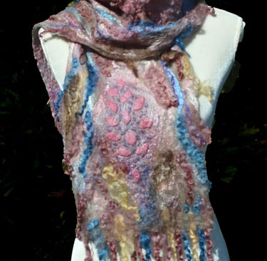 Handmade nuno felted cobweb wool scarf with pink and blue details on a white mannequin torso.