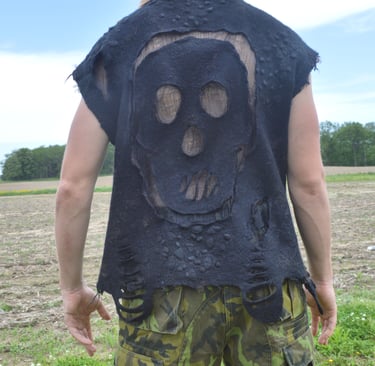 Back view of a person wearing a nuno felted black skull vest 
