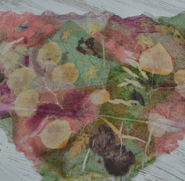 Handmade leaves print silk scarf with botanical leaf impressions in pink, green, and yellow tones.