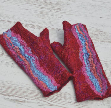 Pair of handmade red wet felted fingerless gloves with blue and pink textured silk accents 