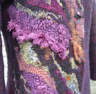 Close-up of a purple nuno felted jacket featuring intricate textures and artistic fiber art details.