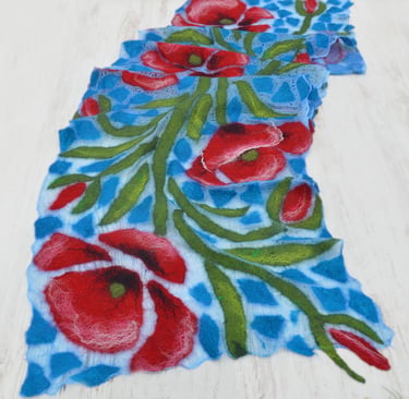 Handmade blue nuno felted scarf featuring vibrant red poppy flowers and green leaves.