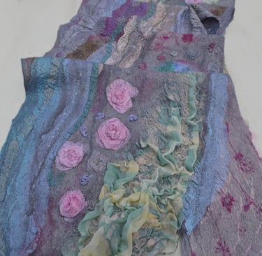 Handmade nuno felted scarf featuring textured silk ruffles and 3D pink rose fiber art details.