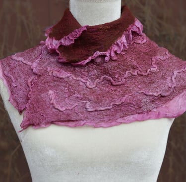 Handmade pink and maroon ruffled nuno felted wool neck warmer displayed on a white mannequin torso.