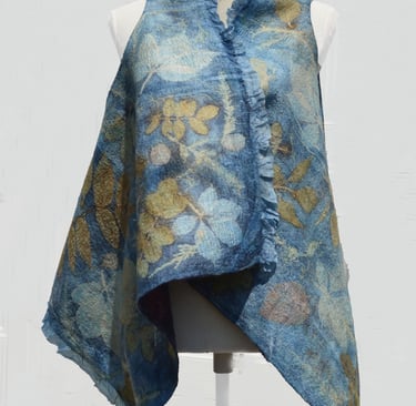 Handmade blue nuno felted vest with botanical leaf prints on a white mannequin torso.