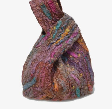 Handmade multi-colored felted wool knot bag with textured fiber art design and earthy tones.