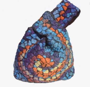 Handmade felted wool mosaic knot bag featuring a colorful stained glass pattern in blue, purple, and orange.