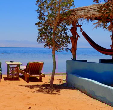 beachview with chaise lounge and bungalow in front of the sea Bedouin star Egypt