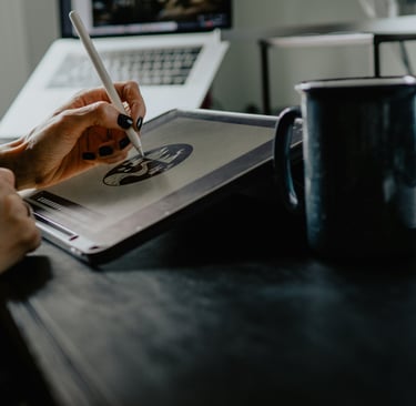 A Person drawing on a tablet creating a professional design in advertising