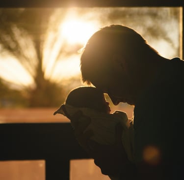parent and baby touching foreheads