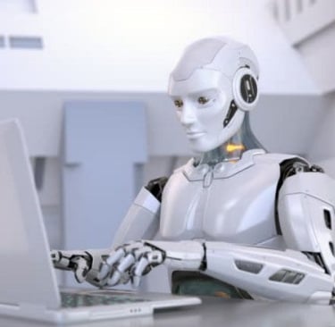 a robot is sitting at a desk with a laptop