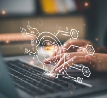 a person using a laptop computer with a laptop on the screen