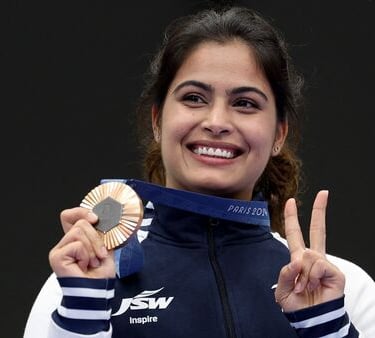 a woman holding a medal and a medal