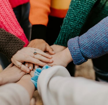 a group of people holding hands together