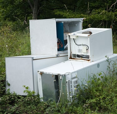large appliances abandoned in a field
