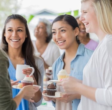 Apartment residents enjoying a community event, representing strong resident retention and engagement.